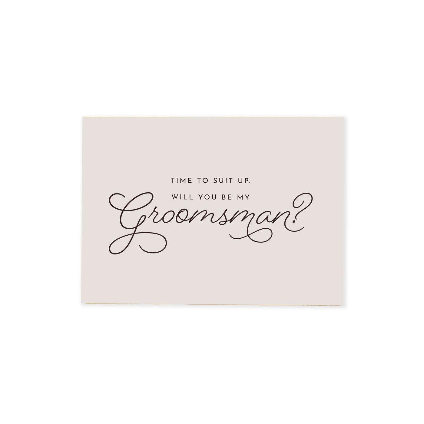 cream colored Be my groomsman proposal card that reads "time to suit up. Will you be my groomsmen?" in cursive black font.