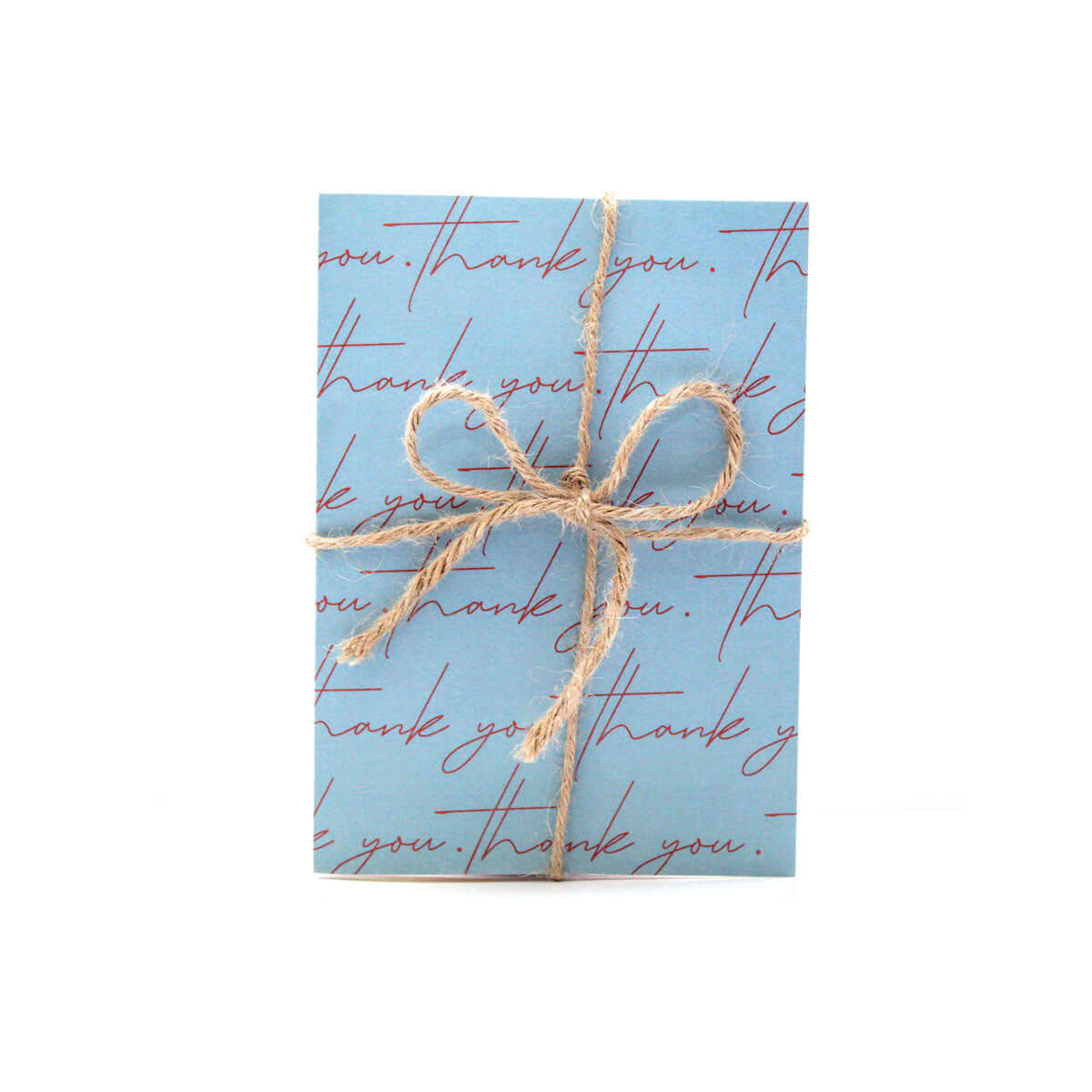 blue card that reads "thank you" in pink cursive writing multiple times on the cover. The card is wrapped in a twine bow wrap