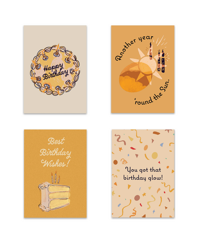 four cards in birthday card set with two cake decorations, sun design, and confetti design.