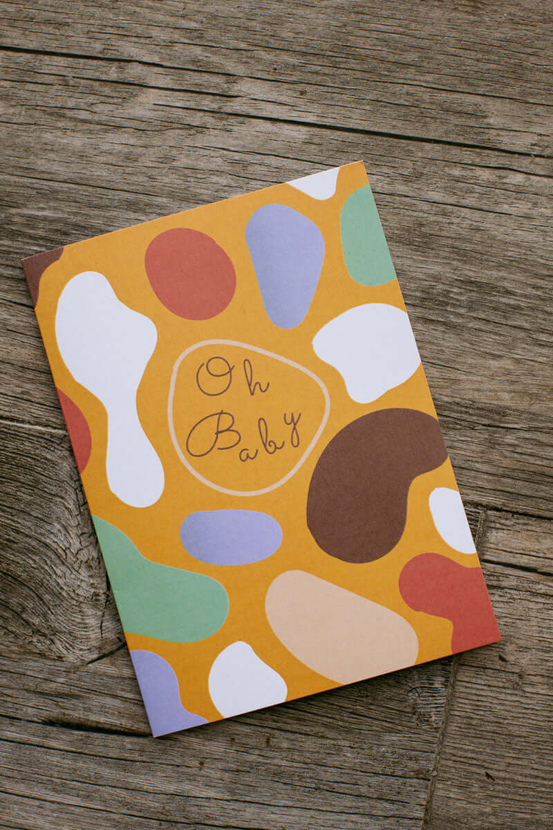 "Oh Baby Card" with colorful abstract illustration with that text "Oh Baby" in the middle written in a childish font