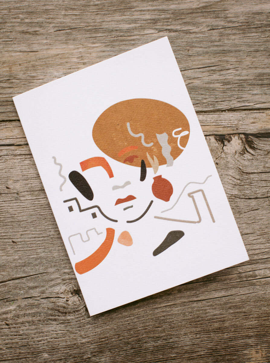 abstract portrait illustration card in neutral color tones placed in wood setting