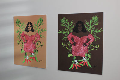 light brown and dark brown dreamgirl art prints with an illustration of a woman wearing a pink dress and her arms on her hips in front of a botanical design