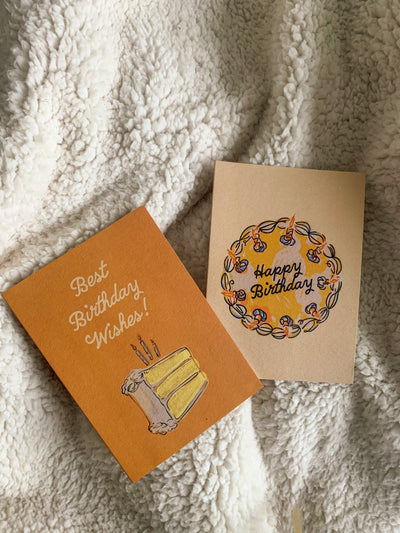 two birthday cards with different cake illustrations. One that reads ""Best birthday wishes" with a slice of cake, and one that reads "Happy birthday" on top of a full cake.