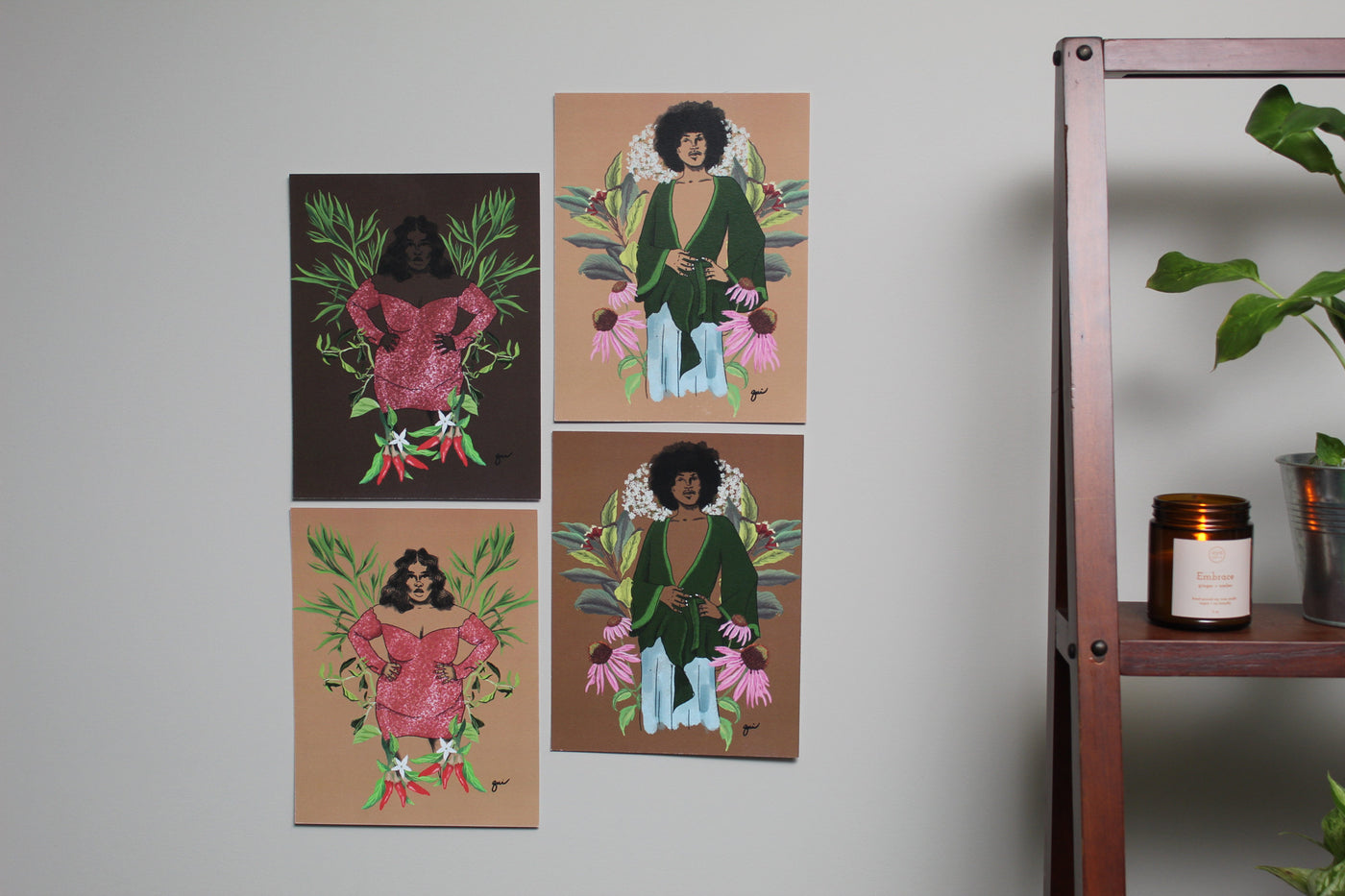 shows 4 arts prints on wall together. two of them are the dream girl art print and two of them are the elder art print.