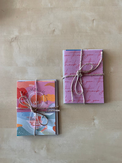 imperfect cards in 2 packs of 4 bundled up by a twine bow.