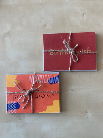 imperfect cards in 2 packs of 4 bundled up by a twine bow.
