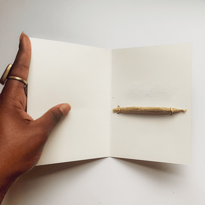 inside of Best Bud greeting card that has a holder for a rolled joint and a joint in it.