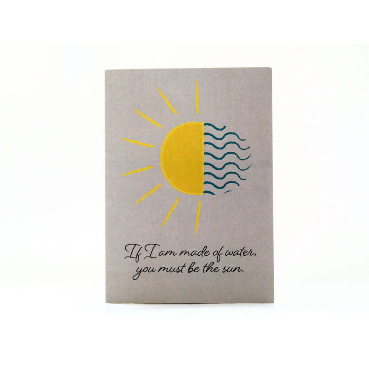 grey water and sun card that reads "If I am mad of water, you must be the sun" in black elegant font with and illustration that is half sun and half water lines