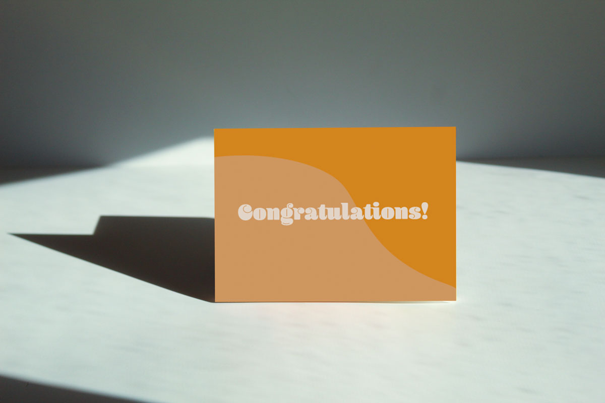 tan and a yellow orangish card that reads congratulations in white retro font