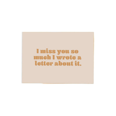 beige horizontal card that reads "I miss you so much I wrote a letter about it". in a yellow brownish text