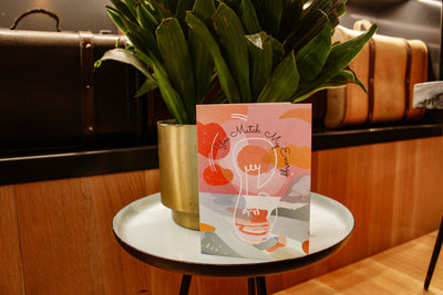 you match my energy card showcased on a side table with decorative plant behind it 